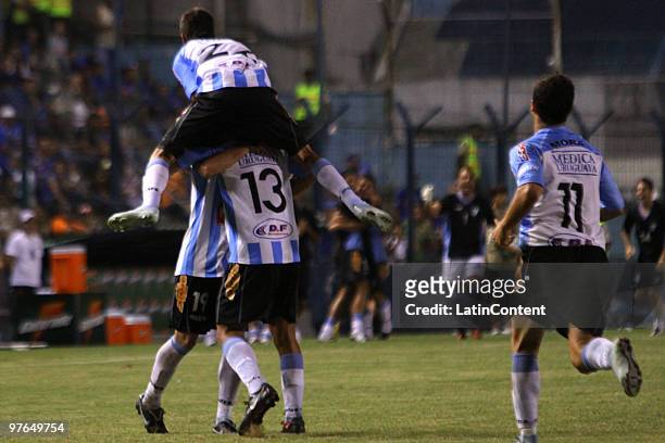 Players Claudio Dadomo, Pablo Cabellero and Rodrigo Mora of Cerro celebrate scored goal against Emelec during a match as part of the Libertadores Cup...