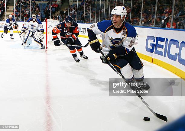 Barret Jackman of the St. Louis Blues skates past Frans Nielsen of the New York Islanders on March 11, 2010 at Nassau Coliseum in Uniondale, New...