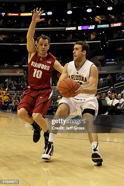 Derek Glasser of the Arizona State Sun Devils is defended by Drew Shiller of the Stanford Cardinal in the first half during the Quarterfinals of the...