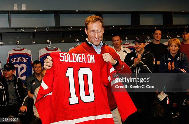 Canadian Minister for National Defence Peter Mackay is presented with a Canadian Paralympic Sledge Ice Hockey Jersey to participate in the scrimmage...