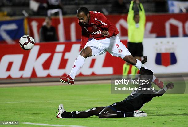 Isac Mina of Deportivo Quito vies for the ball with Hugo Alecsandro of Internacional during a match as part of the Libertadores Cup 2010 at the...