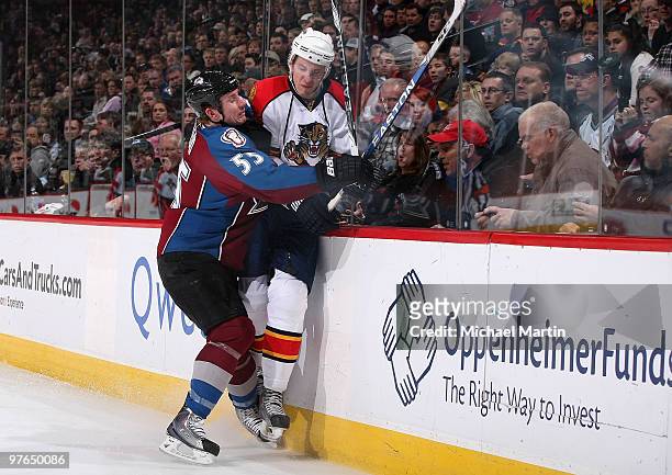 Cody McLeod of the Colorado Avalanche checks Gregory Campbell of the Florida Panthers at the Pepsi Center on March 11, 2010 in Denver, Colorado.