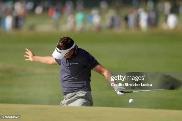 Ian Poulter of England reacts after hitting a shot from a bunker on the eighth hole during the third round of the 2018 U.S. Open at Shinnecock Hills...