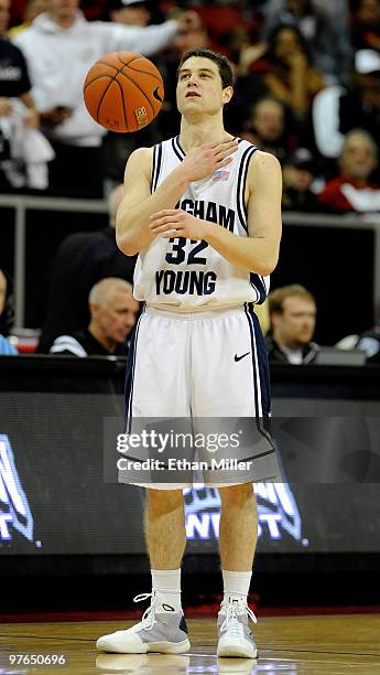 Jimmer Fredette of the Brigham Young University Cougars taps his chest as he dribbles the ball while waiting for time to expire in the team's...