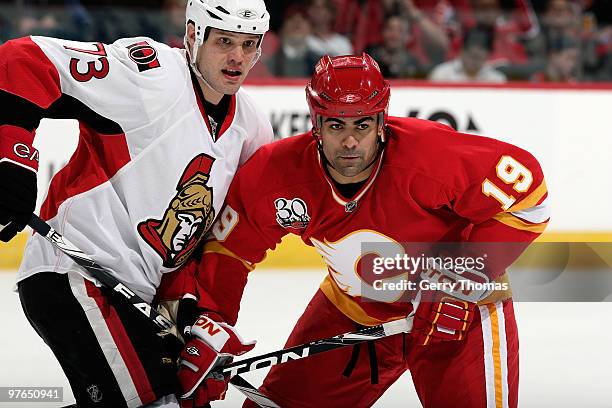 Jamal Meyers of the Calgary Flames skates against Jarkko Ruutu of the Ottawa Senators on March 11, 2010 at Pengrowth Saddledome in Calgary, Alberta,...