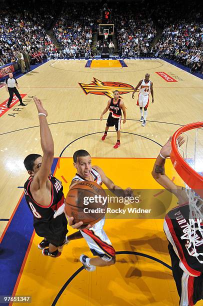 Stephen Curry of the Golden State Warriors elevates for the layup against Nicolas Batum of the Portland Trail Blazers on March 11, 2010 at Oracle...