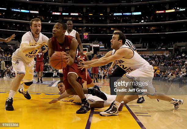 Emmanuel Igbinosa of the Stanford Cardinal is defended by Rihards Kuksiks and Derek Glasser of the Arizona State Sun Devils in the second half during...