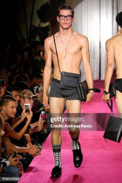 Model walks the runway at the Dolce & Gabbana Naked King Secret Show show during Milan Men's Fashion Week Spring/Summer 2019 on June 16, 2018 in...