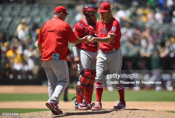 Manager Mike Scioscia of the Los Angeles Angels takes the ball from starting pitcher John Lamb making a pitching change against the Oakland Athletics...