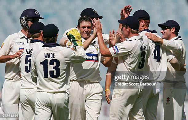 Darren Pattinson of the Bushrangers celebrates with his team mates after dismissing Jason Krejza of the Tigers during day three of the Sheffield...