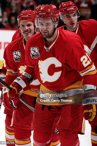 Christopher Higgins, Ian White and Ales Kotalik of the Calgary Flames celebrate a goal against the Ottawa Senators on March 11, 2010 at Pengrowth...