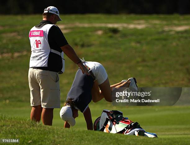 Giulia Sergas of Italy stands on her hands to ease a back problem on the fourth hole during round two of the 2010 Women's Australian Open at The...