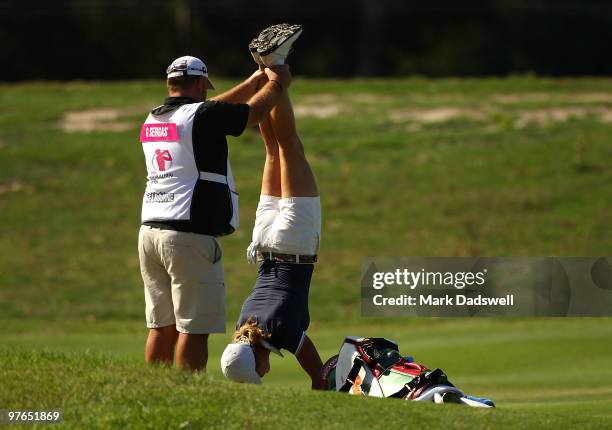 Giulia Sergas of Italy stands on her hands to ease a back problem on the fourth hole during round two of the 2010 Women's Australian Open at The...