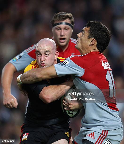 Brendon Leonard of the Chiefs is tackled by Dan Carter of the Crusaders during the round five Super 14 match between the Chiefs and the Crusaders at...