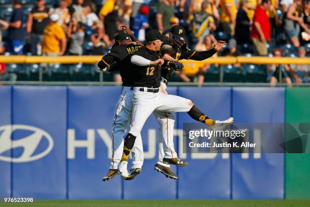 Corey Dickerson of the Pittsburgh Pirates, Austin Meadows of the Pittsburgh Pirates and Starling Marte of the Pittsburgh Pirates celebrates after...