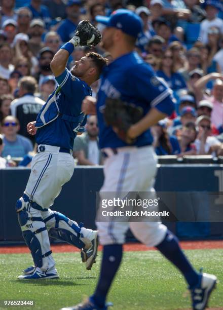 Toronto Blue Jays catcher Luke Maile gets the third out to end the inning as Toronto Blue Jays starting pitcher Marco Estrada is in foreground....