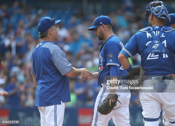 Marco Estrada of the Toronto Blue Jays exits the game as he is relieved by manager John Gibbons in the seventh inning during MLB game action against...