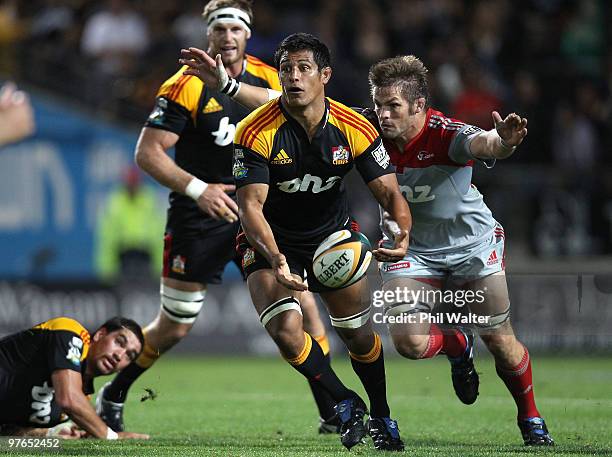 Tanerau Latimer of the Chiefs is tackled by Richie McCaw of the Crusaders during the round five Super 14 match between the Chiefs and the Crusaders...