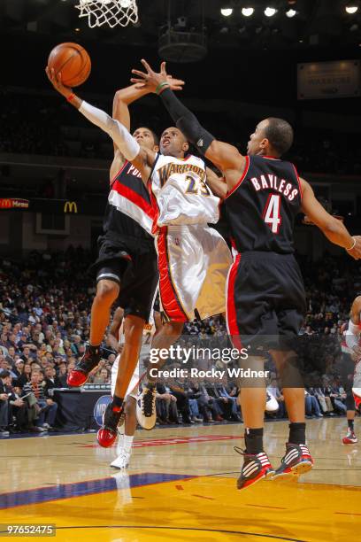 Watson of the Golden State Warriors slashes to the hoop against Jerryd Bayless and Nicolas Batum of the Portland Trail Blazers on March 11, 2010 at...