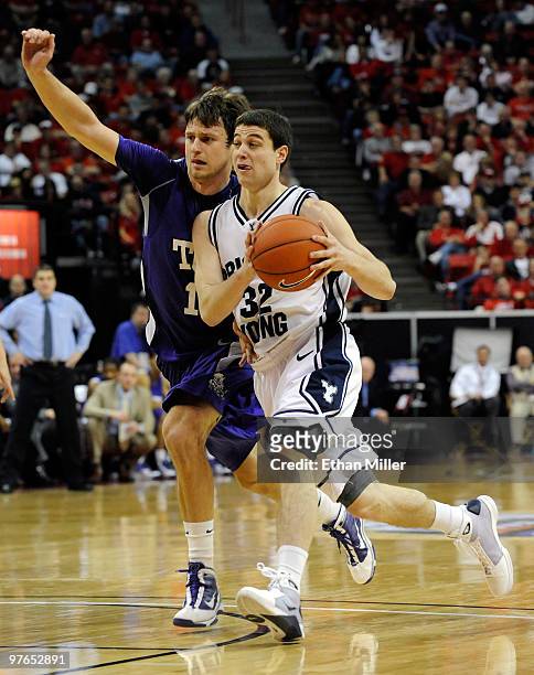Jimmer Fredette of the Brigham Young University Cougars drives around Edvinas Ruzgas of the Texas Christian University Horned Frogs during a...