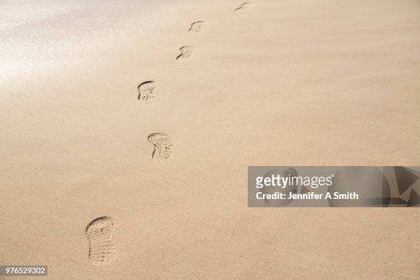 tracks in the sand - shoe print trail stock pictures, royalty-free photos & images
