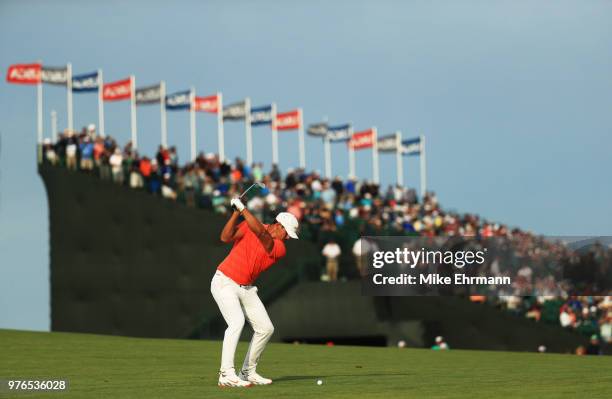 Brooks Koepka of the United States plays an approach shot on the 18th green during the third round of the 2018 U.S. Open at Shinnecock Hills Golf...