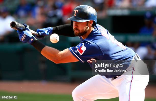 Joey Gallo of the Texas Rangers fouls off a bunt attempt against the Colorado Rockies during the eighth inning at Globe Life Park in Arlington on...