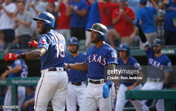 Jurickson Profar and Delino DeShields of the Texas Rangers celebrate with teammates after taking the lead over Colorado Rockies during the eighth...