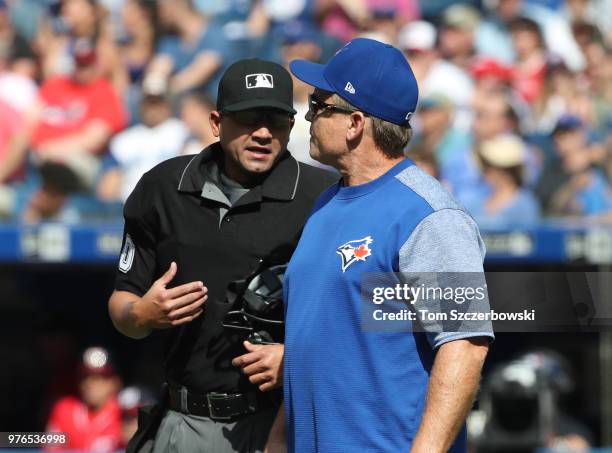 Manager John Gibbons of the Toronto Blue Jays comes out of the dugout to argue a call with home plate umpire Roberto Ortiz in the third inning during...