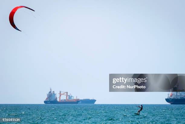 Man kitesurfs in the port town of Ashdod, Israel on June 16, 2018. Ashdod, a popular beach town with the largest port in Israel, is also the sixth...