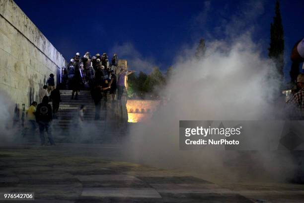 Protesters clash with riot police during a demonstration against the agreement between Greece and FYROM, outside the Greek Parliament in Athens,...