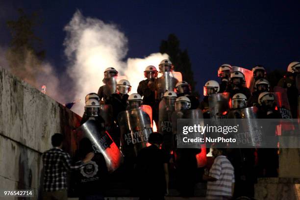 Protesters clash with riot police during a demonstration against the agreement between Greece and FYROM, outside the Greek Parliament in Athens,...