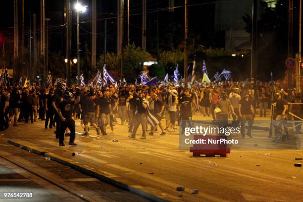 Protesters clash with riot police during a demonstration against the agreement between Greece and FYROM, outside the Greek Parliament in Athens,...