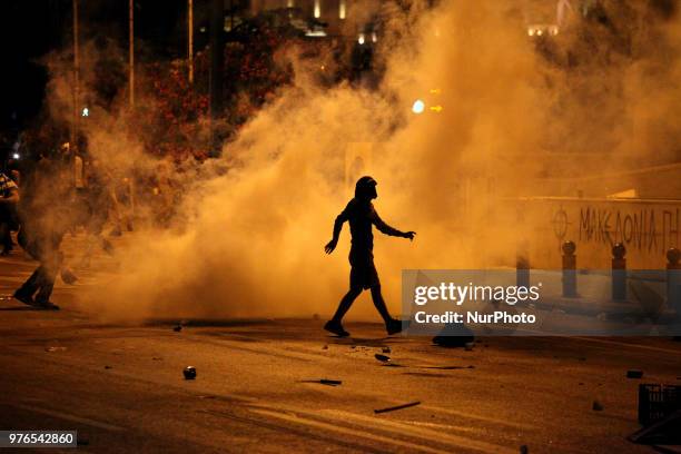 Protesters clash with riot police during a demonstration against the agreement between Greece and FYROM, outside the Greek Parliament in Athens,...