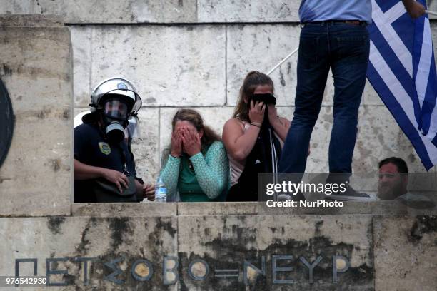 Protesters clash with riot police during a demonstration against the agreement between Greece and FYROM, outside the Greek Parliament in Athens,...