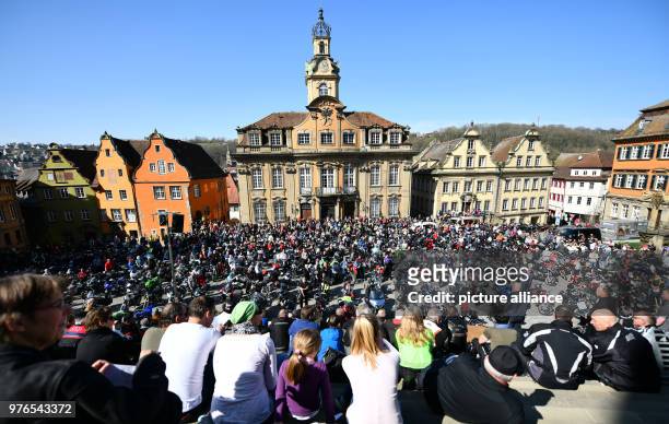 April 2018, Germany, Schwaebisch Hall: Numerous visitors and motorcyclists with their bikes standing at the Marktplatz in front of the town hall...