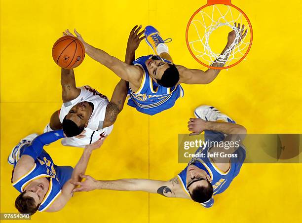 Michael Roll of the UCLA Bruins, Lamont Jones of the Arizona Wildcats, Tyler Honeycutt of the Bruins and Reeves Nelson of the Bruins fight for a...