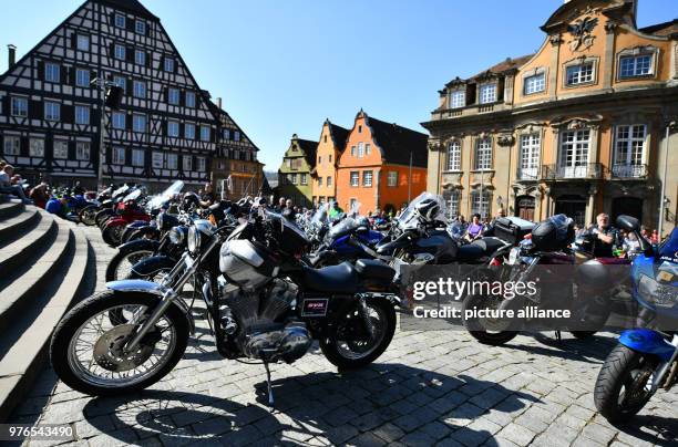 April 2018, Germany, Schwaebisch Hall: Numerous visitors and motorcyclists with their bikes standing at the Marktplatz in front of the town hall...