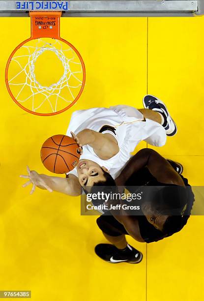 Max Zhang of the Cal Golden Bears and Jeremy Jacob of the Oregon ducks battle for a rebound during the Quarterfinals of the Pac-10 Basketball...