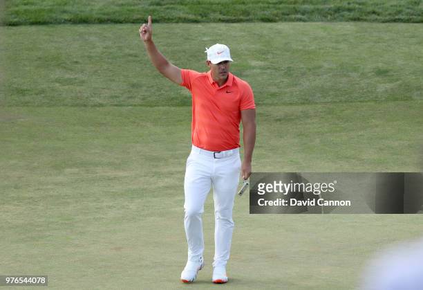 Brooks Koepka of the United States celebrates holing a long par putt on the 14th hole during the third round of the 2018 US Open at Shinnecock Hills...