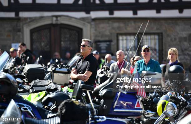 Motorcyclists stand with their bikes during the "Biker Gottesdienst" at the Marktplatz in front of the town hall in Schwäbisch Hall, Germany, 08...