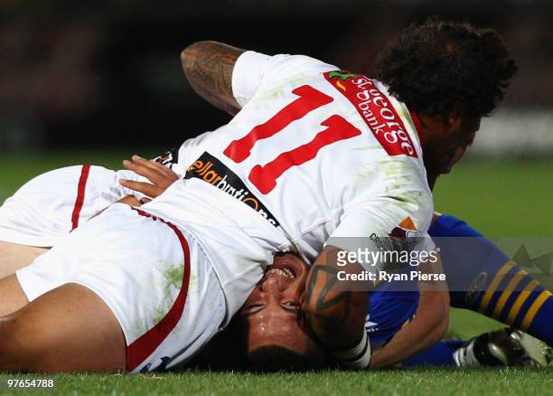 Jeremy Smith of the Dragons tackles Feleti Mateo of the Eels during the round one NRL match between the Parramatta Eels and the St George Illawarra...