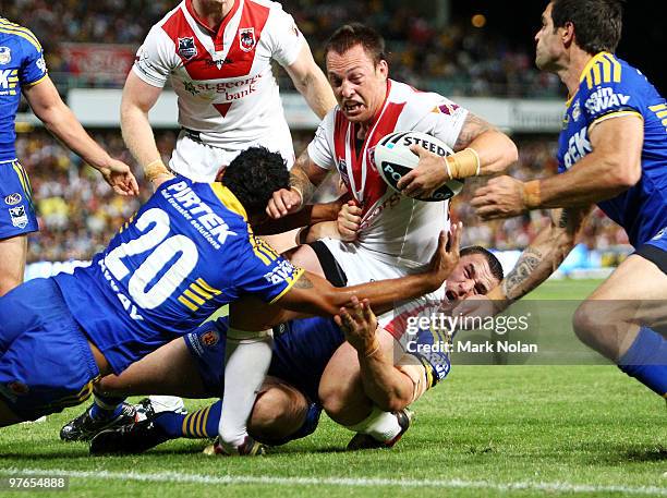 Nathan Fien of the Dragons injures his leg in this tackle during the round one NRL match between the Parramatta Eels and the St George Illawarra...