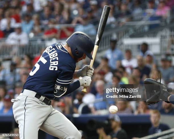 Pinch hitter Cory Spangenberg of the San Diego Padres is hit by a pitch in the ninth inning during the game against the Atlanta Braves at SunTrust...