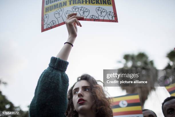 Dpatop - A woman holds a placard during a protest against the plan to deport African asylum seekers to Uganda, in Tel Aviv, Israel, 09 April 2018....