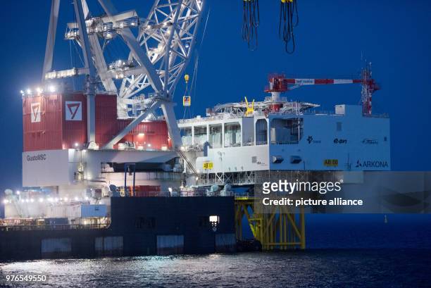 April 2018, Germany, Sassnitz: The crane ship 'Oleg Strashnov' is utilised to install a 4000 tonne transformer platform at the offshore wind farm...