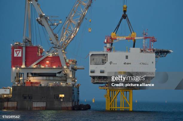 April 2018, Germany, Sassnitz: The crane ship 'Oleg Strashnov' is utilised to install a 4000 tonne transformer platform at the offshore wind farm...