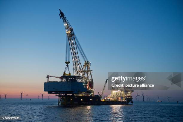 April 2018, Germany, Sassnitz: The crane ship 'Oleg Strashnov' is utilised to install a 4000 tonne transformer platform at the offshore wind farm...