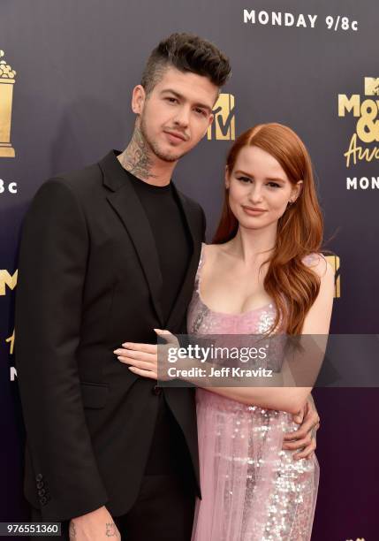 Actors Travis Mills and Madelaine Petsch attend the 2018 MTV Movie And TV Awards at Barker Hangar on June 16, 2018 in Santa Monica, California.