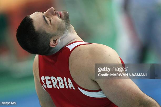 Serbia's Asmir Kolasinac reacts as he competes in the men's shot put group B qualifying round at the 2010 IAAF World Indoor Athletics Championships...